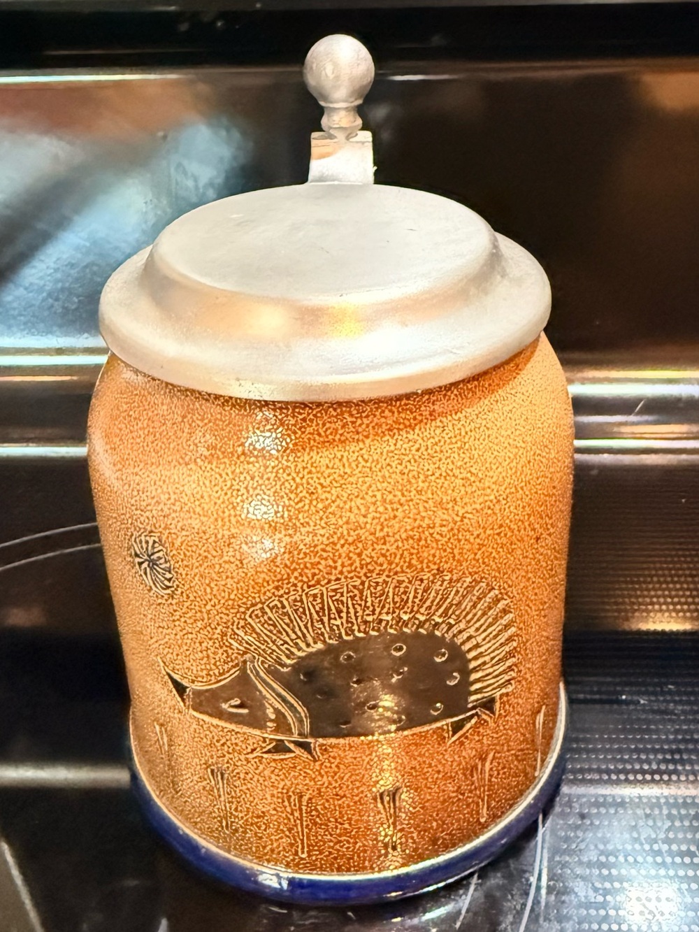 salt-glazed ceramic beer stein featuring a hedgehog studio potter Wim Mühlendyck